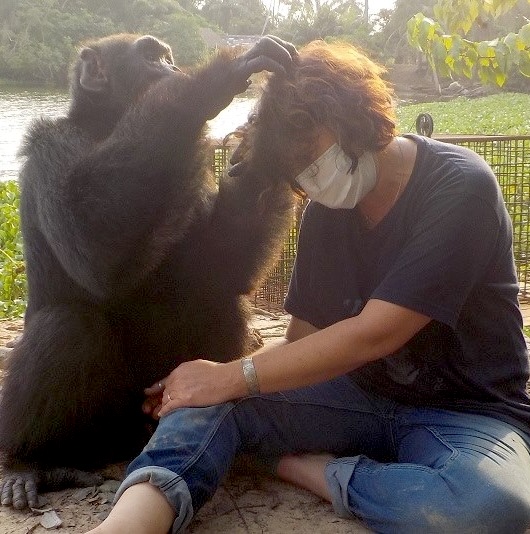 Estelle with chimp looking at her hair